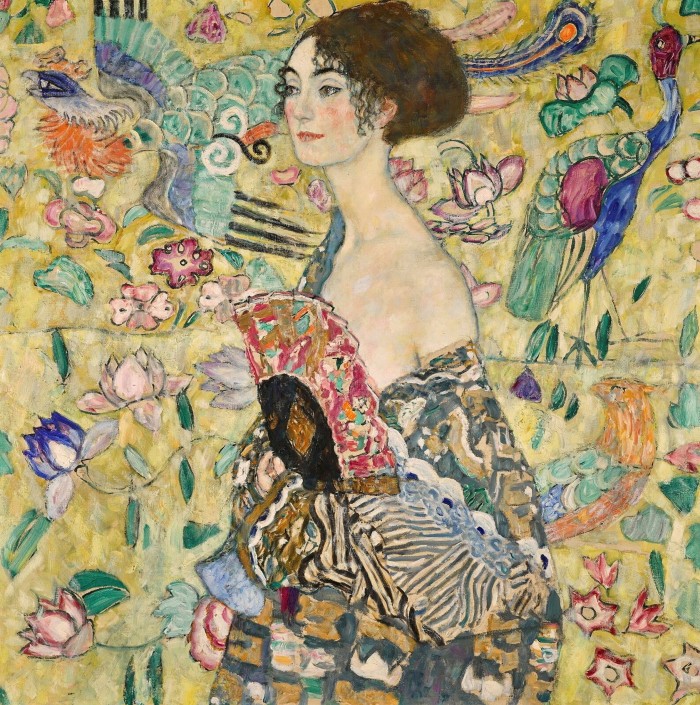 Painting of a woman whose robe is slipping off her shoulder against a background of yellow wallpaper with peacocks