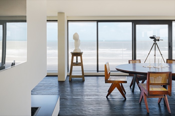 An apartment on the Belgian coast – the oval dining table was also designed by Vervoordt