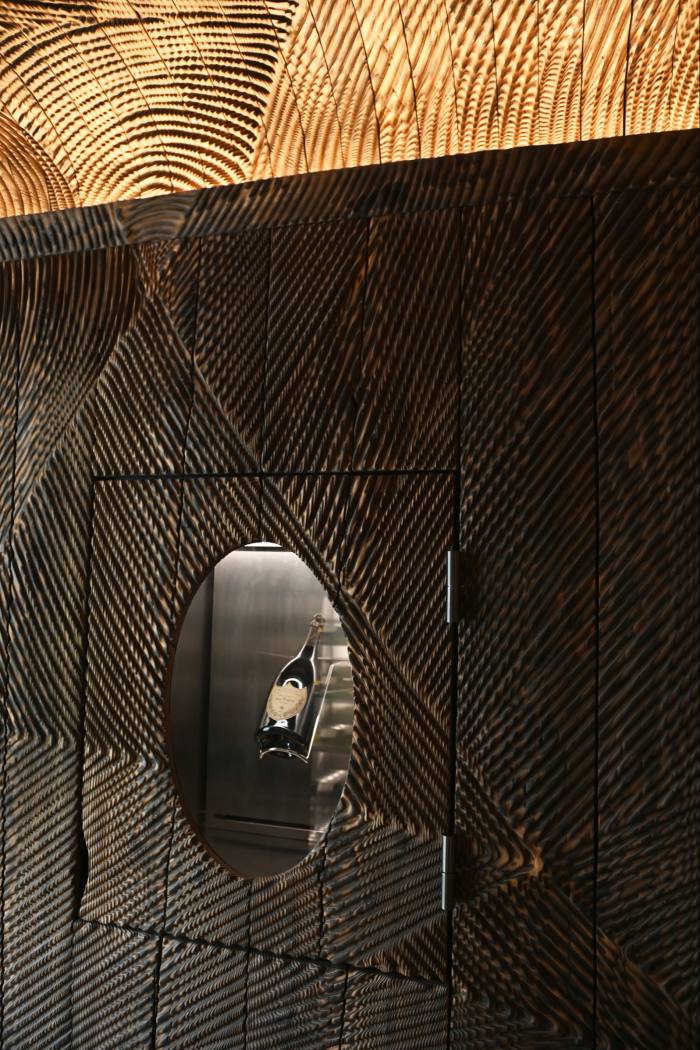 The wine vault of the restaurant by Etienne Moyat, with carved wood walls