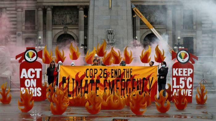 Activists symbolically set George Square in Glasgow on fire with an art installation of faux flames and smoke ahead of COP26