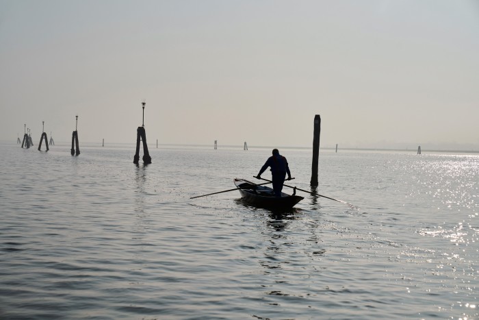 Traditional Venetian rowing in the lagoon