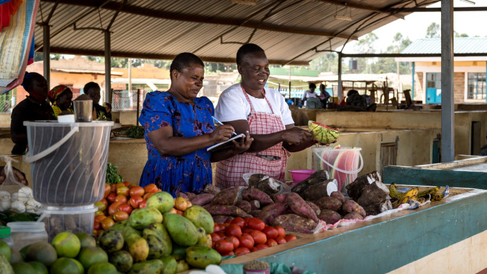 Entrepreneurs operate their business selling produce at their local market