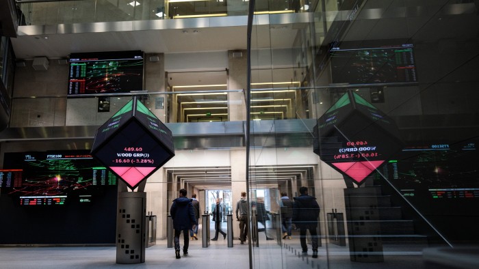 Share price information is displayed on screens at the London Stock Exchange offices