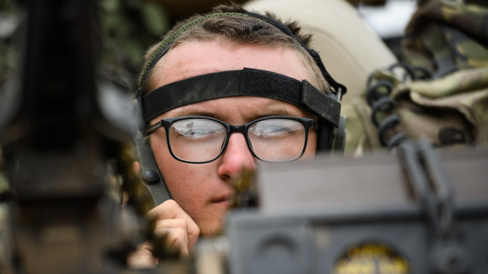 A soldier from the Long Range Reconnaissance Task Group listens to his radio