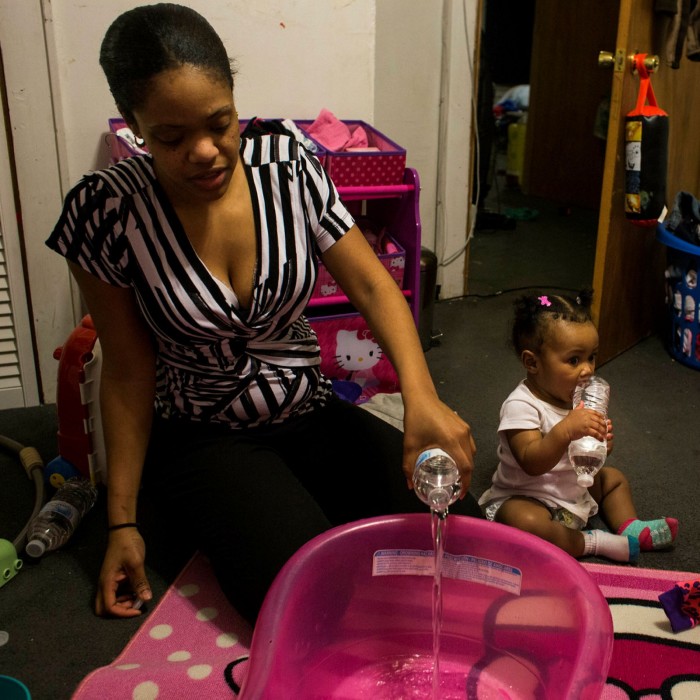 A mother in Flint, Michigan prepares a bath for her baby daughter with bottled water, during the city’s 2014 water supply crisis