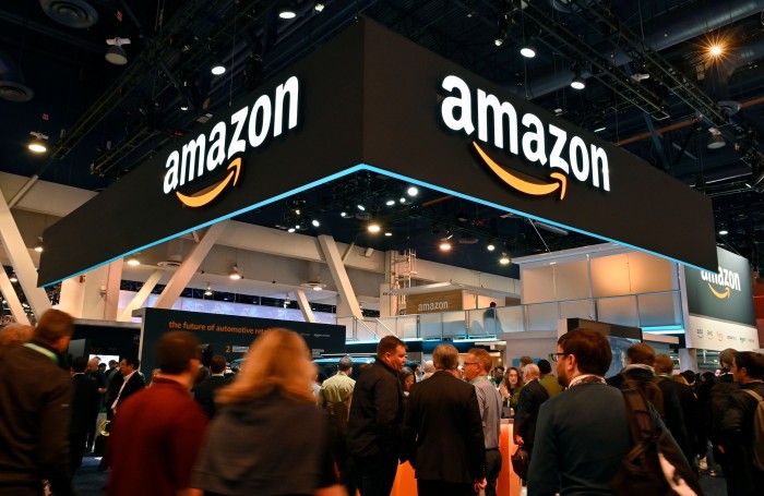 attendees walk by the Amazon booth during CES 2020 at the Las Vegas Convention Center on January 7, 2020 in Las Vegas, Nevada