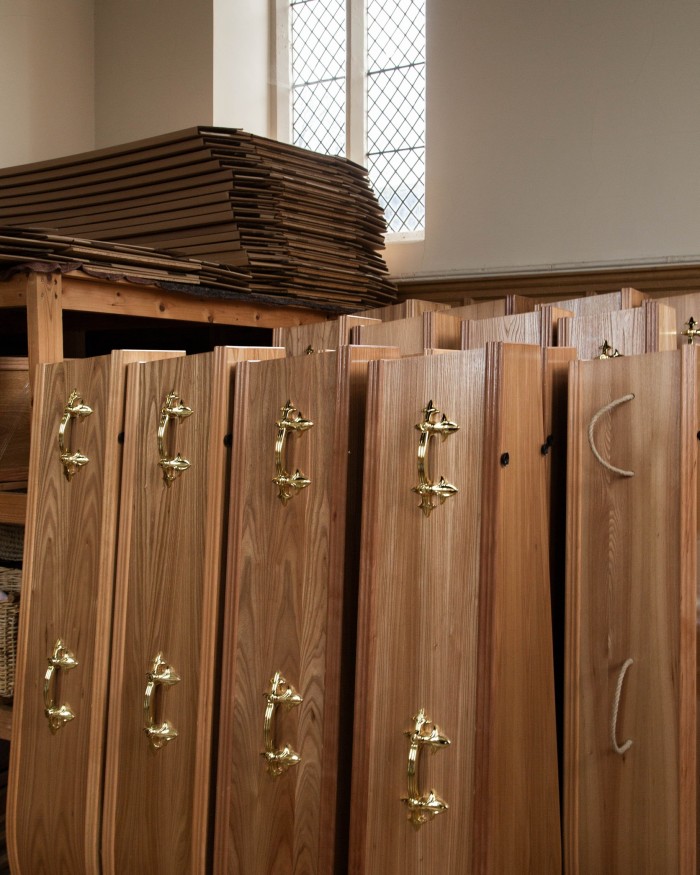 A line of coffins stored on end in Lambeth Cemetery’s Old Chapel