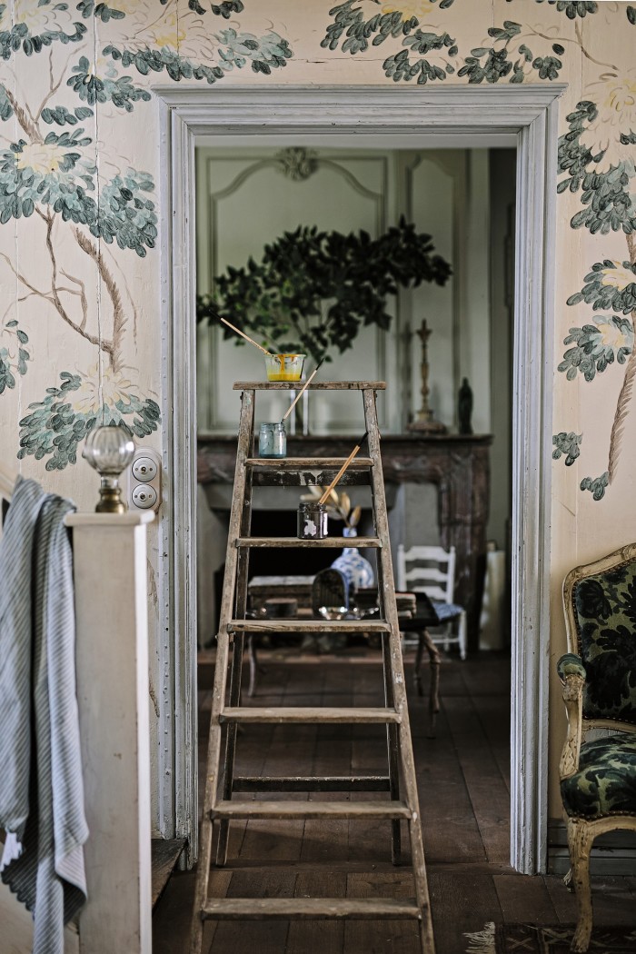 A ladder in the house’s entrance hall, with Farelly’s handpainted murals