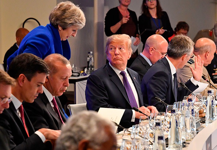 U.S. President Donald Trump looks at British Prime Minister Theresa May during a dinner of leaders at the Art and History Museum at the Park Cinquantenaire in Brussels