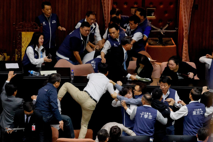 Taiwan lawmakers argue an exchange blows during a parliamentary session in Taipei on Friday
