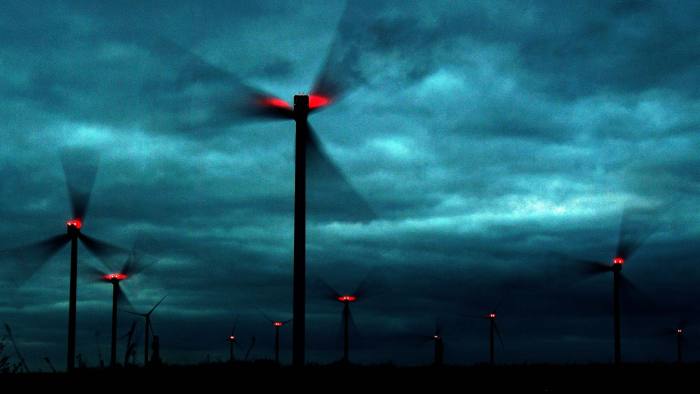 Wind turbines under a dark sky