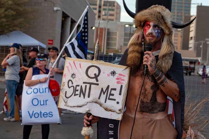 Jake Angeli, a QAnon  conspiracy theorist’, protests outside an election counting station in Phoenix, Arizona, in 2020