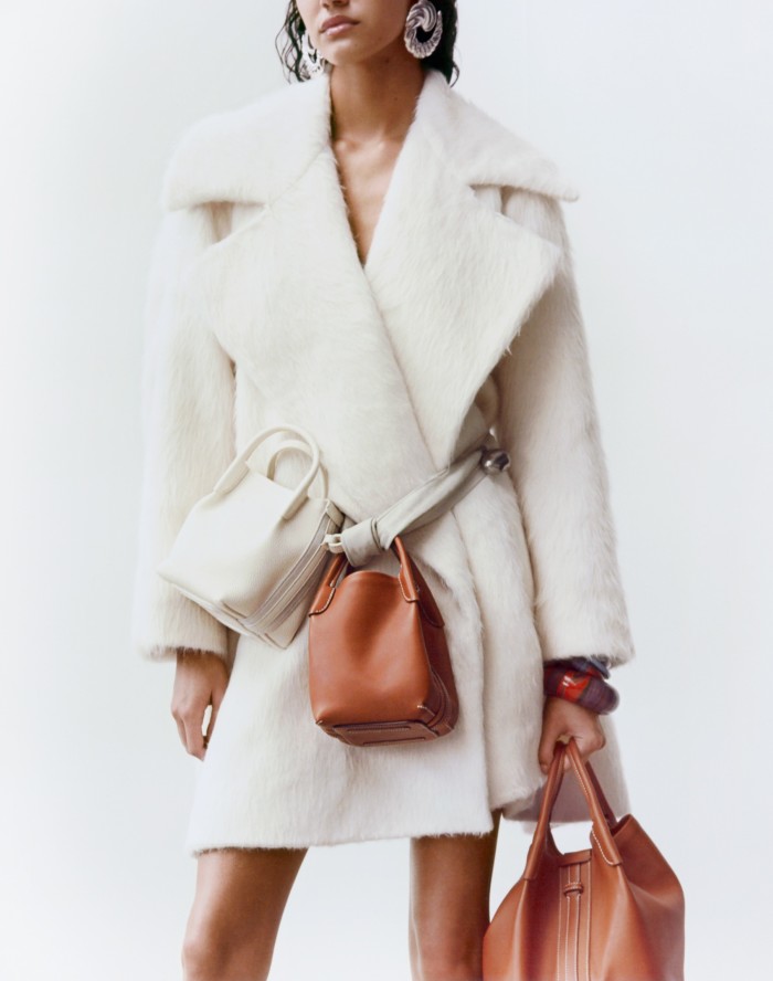 Loewe wool and alpaca-mix Trapeze coat, £2,950. Loro Piana leather Micro Bale bags (on belt), £2,165 each, and leather large Bale bag, £3,070. Hermès lacquered-wood small Marbling bracelet, £185, lacquered-wood Stellaire bangle, £245, and Stellaire bracelet, £175. The Row brass and suede Pills necklace (worn as belt), £1,600