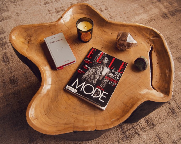 Balinese side table (sourced by Maison Sarah Lavoine) with a book by Sophie Calle, a Cire Trudon candle and rock crystals from Goa