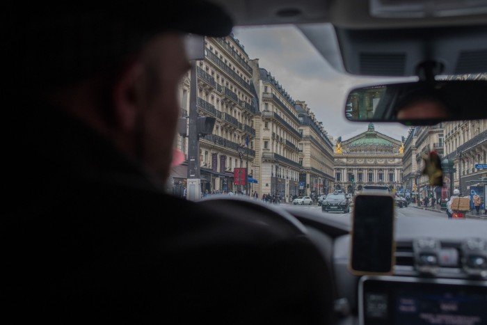 An Uber driver travels towards the Palais Garnier Opera House in Paris, France 
