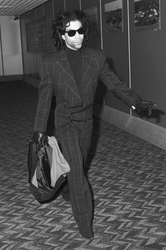Prince in his windowpane suit at London Heathrow, 1989