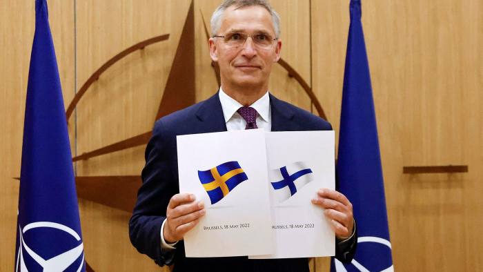 Nato’s Jens Stoltenberg poses during a ceremony to mark Sweden’s and Finland’s applications for membership in Brussels