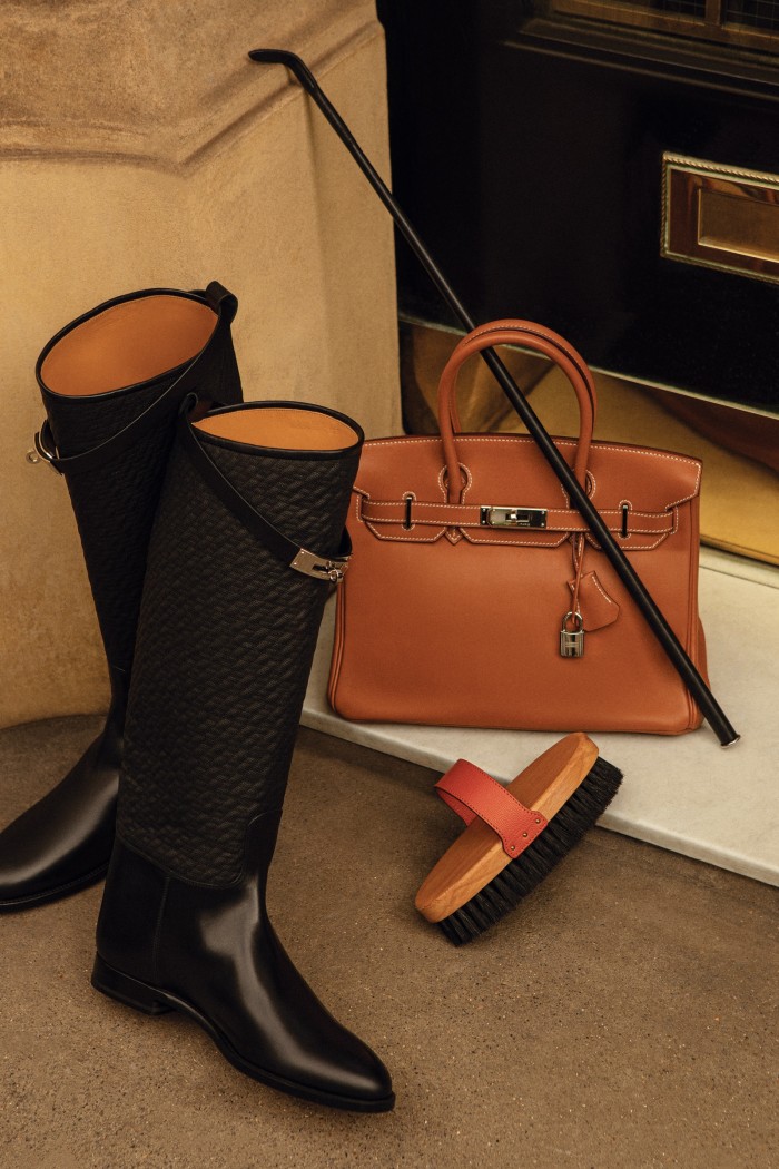 Clockwise from top: Hermès leather Essentielle riding crop, £1,050, swift leather Birkin 30 bag, £8,240, beechwood and pig-bristle soft body brush, £150, and leather quilting jumping boots, £2,060