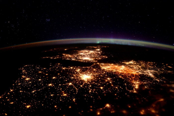 A night-time view from the International Space Station shows energy-hungry cities in the UK, France and Belgium, plus an auroral display at top