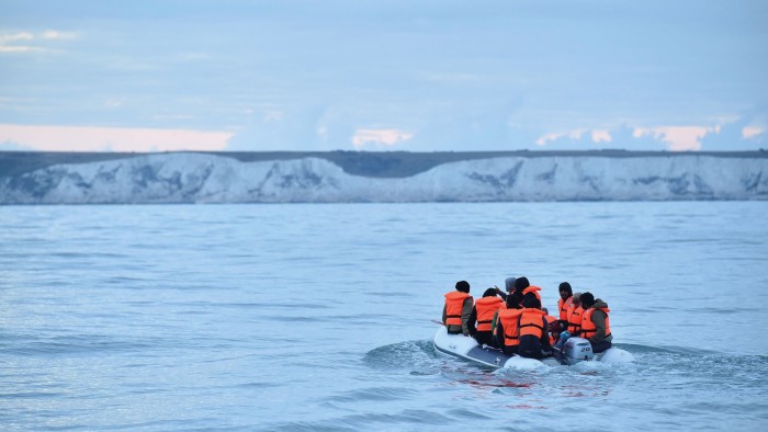 Migrants in a dinghy sail in the Channel toward the south coast of England on September 1, 2020 after crossing from France