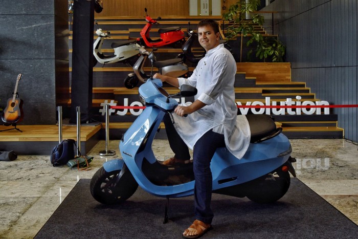 Ola chief executive Bhavish Aggarwal poses on the new Ola electric scooter. He says investors will see a lot of value creation in India