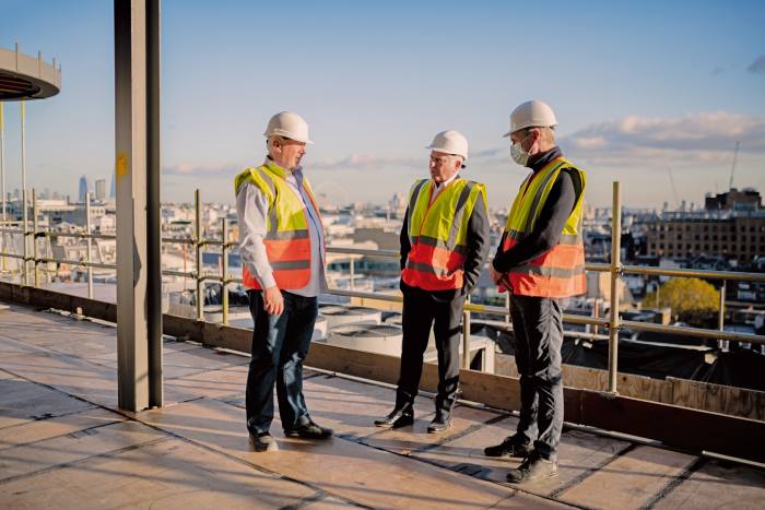 McKillen (centre) on the roof of Claridge’s with construction director Norman McKibbin and Mark Allen, director of quantity surveyors Rainey & Best