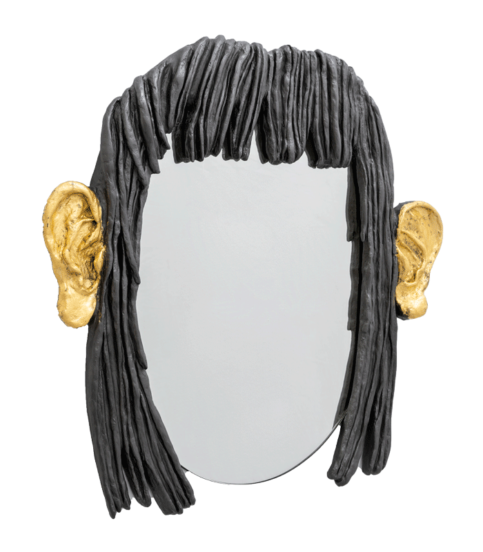 An oval mirror with black “hair” around it and large gilded ears