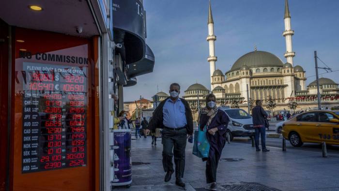 A board displays currency exchange rate information in Taksim Square in Istanbul