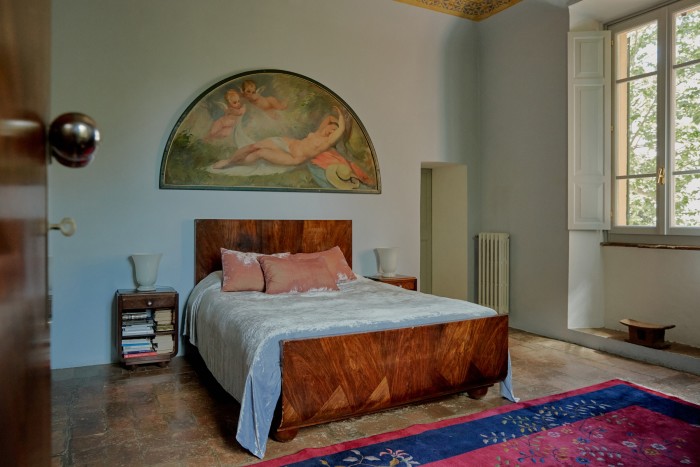 A c1920 painting by Henry Fehr hangs above Majorelle furniture in the master bedroom