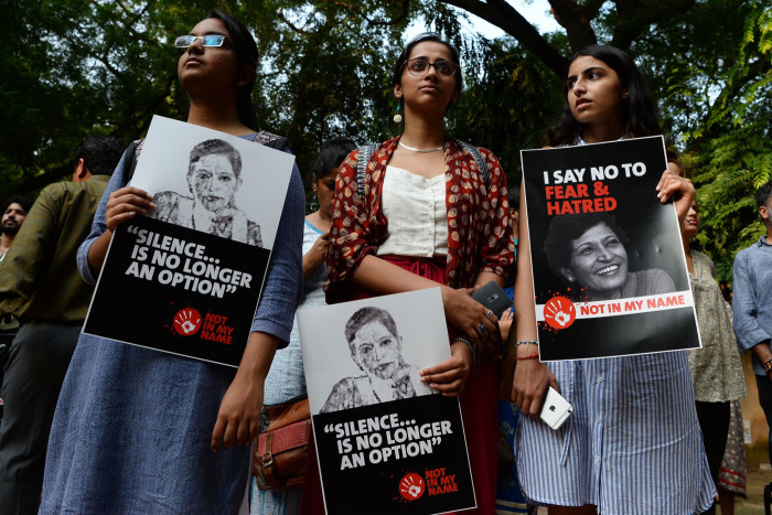 Indian demonstrators hold placards with the picture of Indian journalist Gauri Lankesh during a ‘Not In My Name’ protest in New Delhi 
