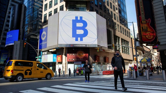 Monitors display Bitcoin signage at the Nasdaq MarketSite in New York