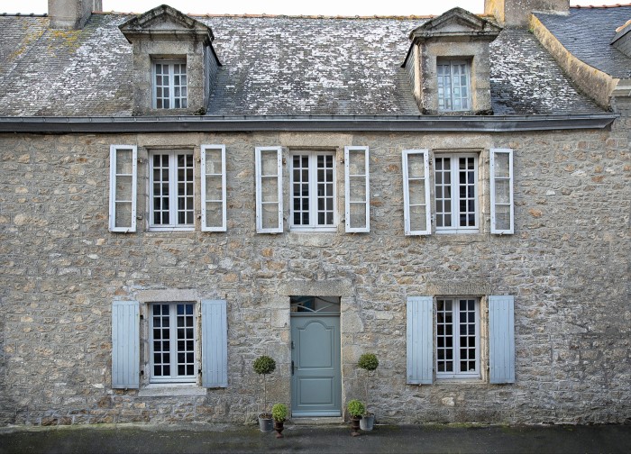 The 17th-century façade of Maison Lescop in Port-Louis, Brittany, with its traditional double windows