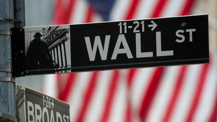 Wall Street street sign in front of the New York Stock Exchange
