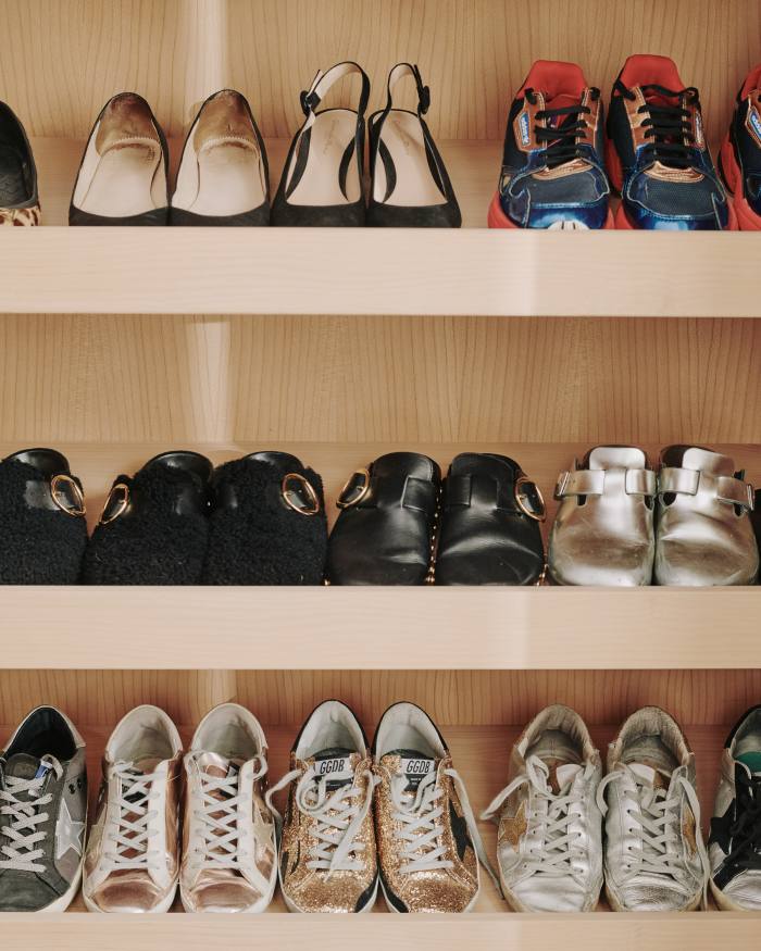 Shelves of sneakers and clogs in Dawn’s dressing room