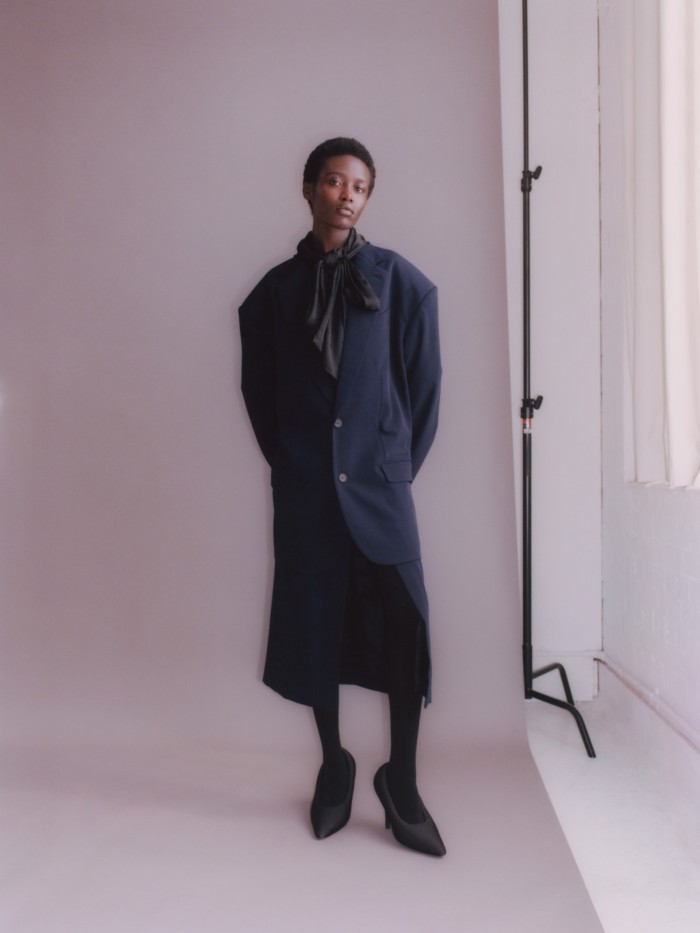 Akidor wears stretch wool-twill jacket, £2,450, and matching skirt, £1,090. Jacquard blouse, £1,550. Spandex XL 110mm pumps, £1,050. All Balenciaga Garde-Robe