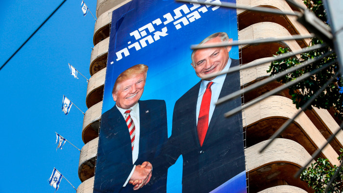A Israeli Likud Party election banner  shows Israeli Prime Minister Benjamin Netanyahu shaking hands with US President Donald Trump