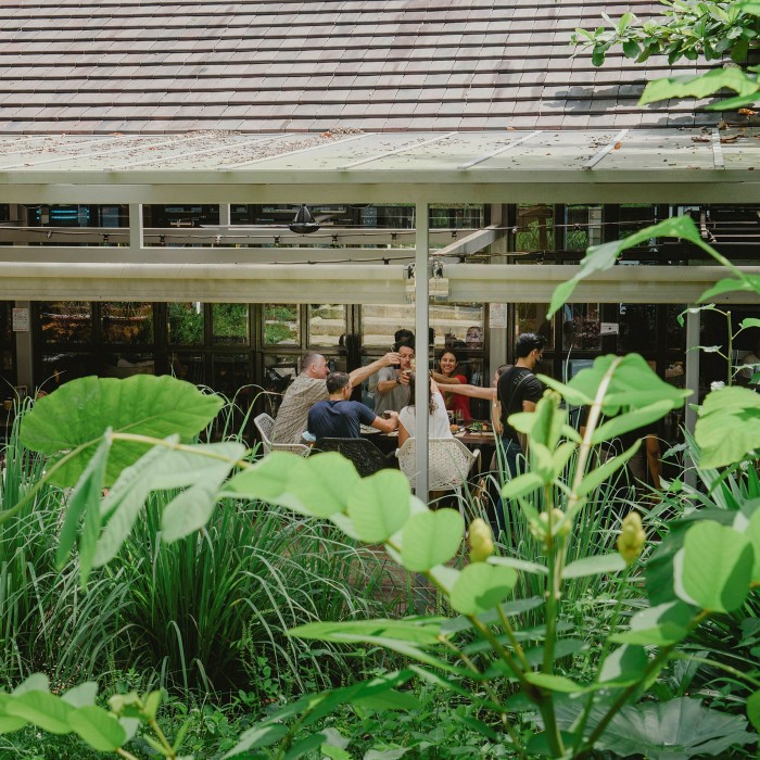 The restaurant is surrounded by lush greenery