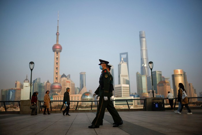 Paramilitary police officers march at the Bund, in front of Lujiazui financial district of Pudong in Shanghai