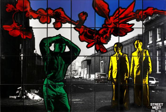 A multicoloured photo sectioned into grids with a black and white urban scene in the background, a green man in the foreground and two yellow men in suits to the right