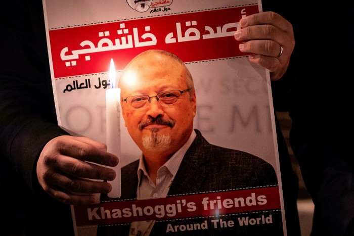 A demonstrator holds a poster picturing Saudi journalist Jamal Khashoggi 