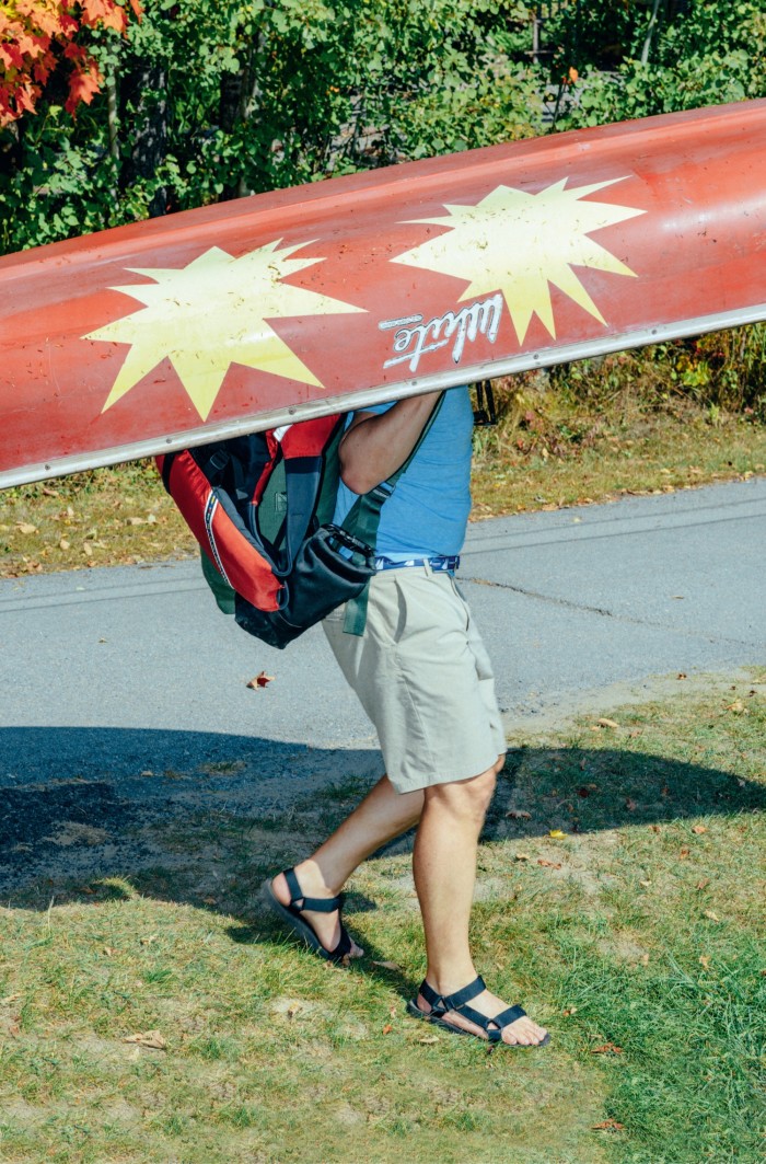 Brendan Greeley carries his canoe Exploding Jane