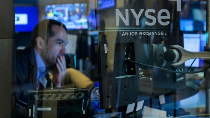 A trader works during the opening bell at the New York Stock Exchange 