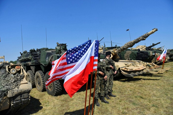 Soldiers stand next to tanks during Polish-US military exercises, within the framework of the Emergency Deployment Readiness Exercise, in Drawsko Pomorskie, northwestern Poland, in 2020