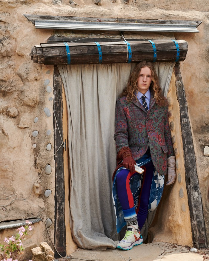 Cian wears Brioni cotton shirt, £460, and silk tie, £230. Giorgio Armani woven wool jacket, £2,000 for suit. Phipps wool leggings, £170. Etro sneakers, £475. Nick Fouquet – Federico Curradi wool/cashmere socks, £266. Isa Boulder acrylic and elastane Raglan gloves, £140 for pair. Hermès silk and cotton Mr Farrier scarf (around waist), £594