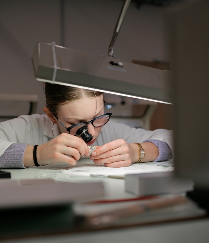 A lycée student working on a watch