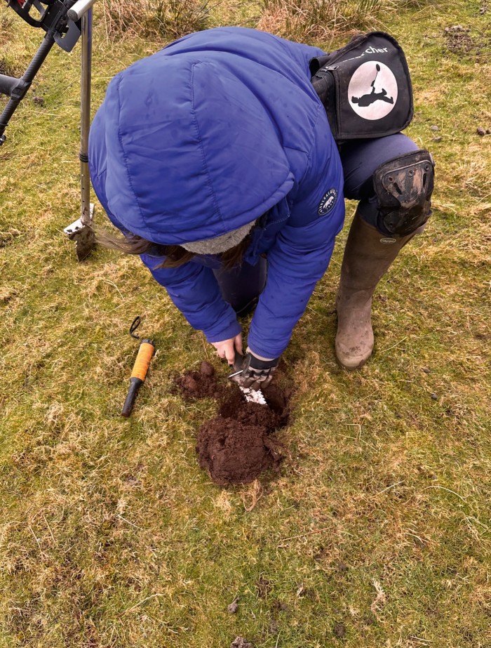 One of Cameron’s fellow detectorists digs up a find