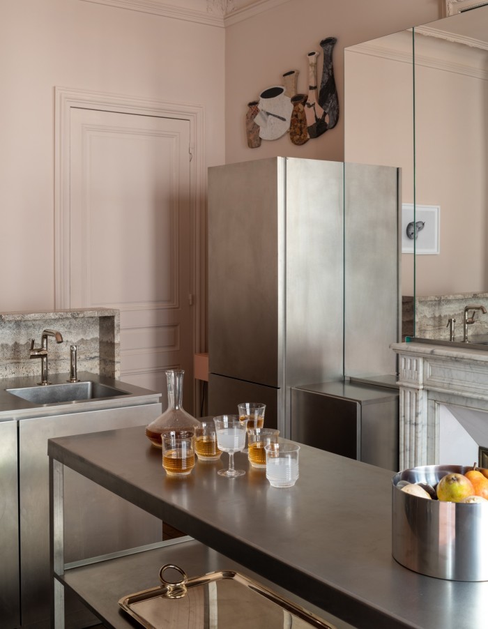 This floating stainless-steel kitchen contrasted with pastel-pink walls was designed by Rodolphe Parente for the Canal Saint-Martin project in Paris. 