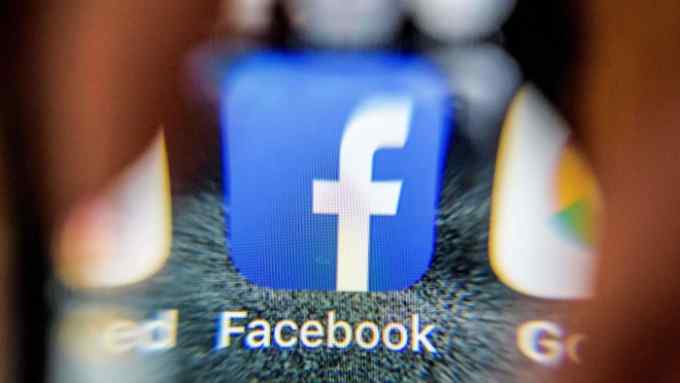 An illustration picture taken through a magnifying glass on March 28, 2018 in Moscow shows the icon for the social networking app Facebook on a smart phone screen. Facebook said on March 28, 2018 it would overhaul its privacy settings tools to put users &quot;more in control&quot; of their information on the social media website. The updates include improving ease of access to Facebook's user settings, a privacy shortcuts menu and tools to search for, download and delete personal data stored by Facebook. / AFP PHOTO / Mladen ANTONOVMLADEN ANTONOV/AFP/Getty Images