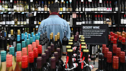 A patron stands in front of a shelf full of wine bottles at The Liquor Store.Com on March 20, 2020 in the Brooklyn borough of New York. - Liquor sales have exploded in New York since a national emergency was declared and New York closed all its theatres, bars and restaurants, while virtual cocktail parties with &quot;quarantinis&quot; are on the rise. (Photo by Angela Weiss / AFP) (Photo by ANGELA WEISS/AFP via Getty Images)