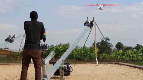 TOPSHOT - A technician of California-based robotics company Zipline launches a drone, on October 12, 2016 in Muhanga, 50 kilometres (31 miles) west of the capital Kigali. On October 14, 2016, Rwanda inaugurated a drone operation that its backers hope will kickstart a revolution in the supply of medical care in rural parts of Africa, in the first instance by delivering batches of blood to 21 clinics in the west of the country. / AFP / STEPHANIE AGLIETTI (Photo credit should read STEPHANIE AGLIETTI/AFP/Getty Images)
